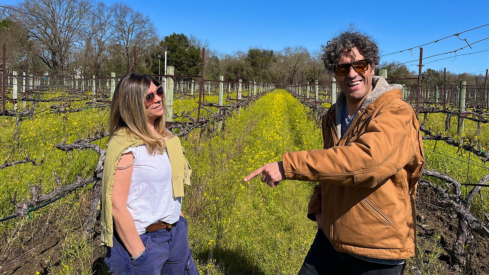 Letizia and Enrico Bertoz standing in a block of Malvasia in Catie's Corner Vineyard in spring